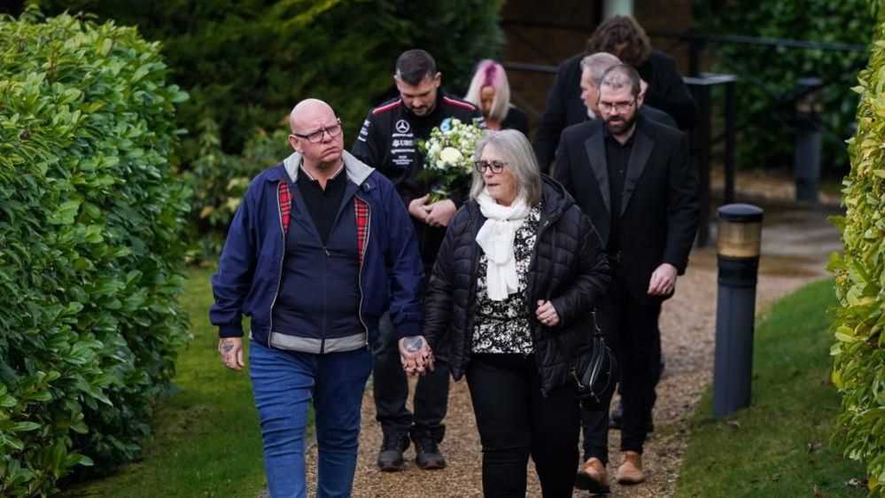 Members of Harry Dunn's family walking to the crematorium