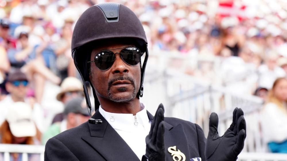 Snoop Dogg watching the Dressage Team Grand Prix Special at the Chateau de Versailles on the eighth day of the 2024 Paris Olympic Games in France. Picture date: Saturday August 3, 2024