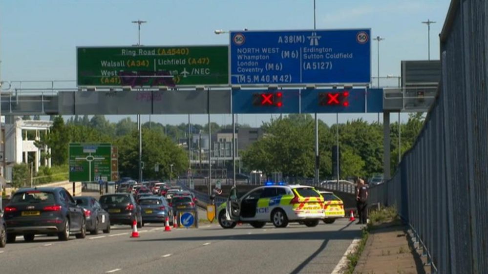 Police car at the scene as cars are stuff in traffic