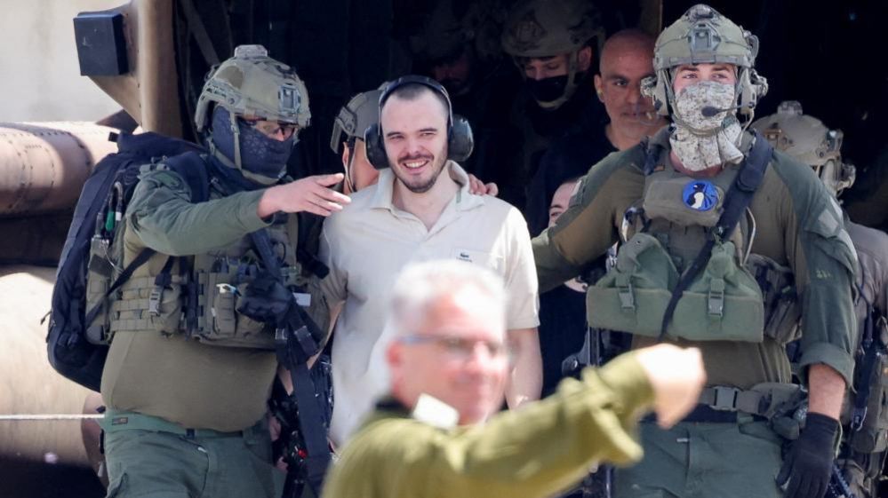 Andrey Kozlov is escorted by Israeli soldiers towards a hospital