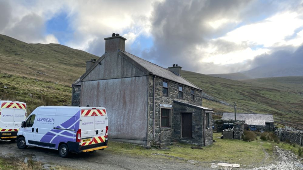 Hafodty farmhouse below Snowdon, with Openrach vans outside