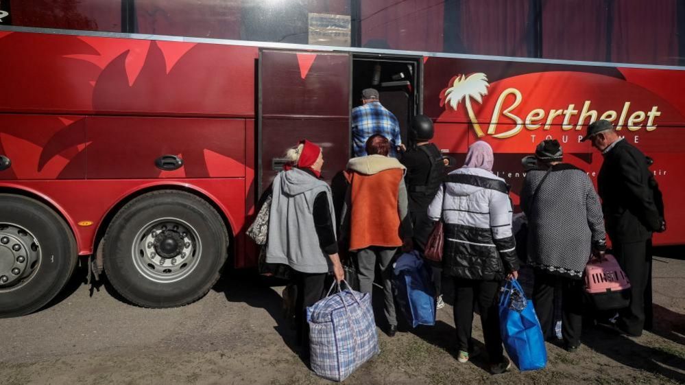 People boarding a bus to take them away from Vovchansk