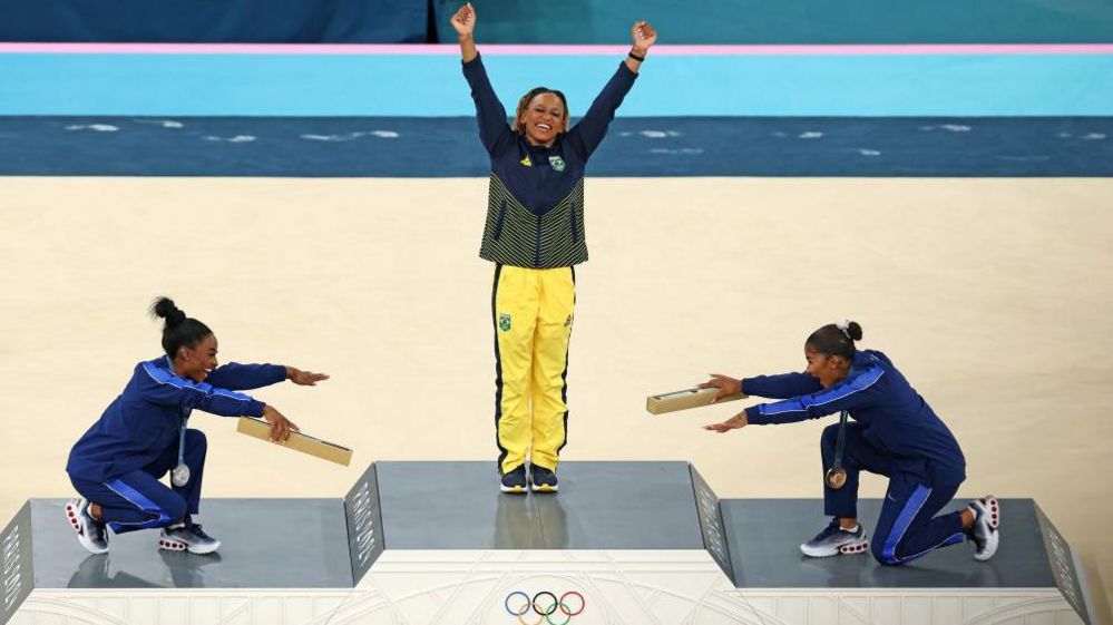 Simone Biles and Jordan Chiles bow down to gold medallist Rebeca Andrade after women's floor final