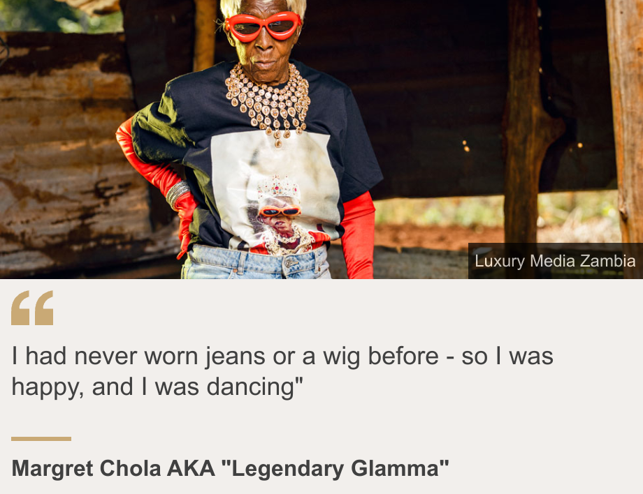 "I had never worn jeans or a wig before - so I was happy, and I was dancing"", Source: Margret Chola AKA "Legendary Glamma", Source description: , Image: Margret Chola in jeans, a blond wig and red gloves. She also wearing a T-shirt with her image on the front, big jewelled necklace and red sunglasses