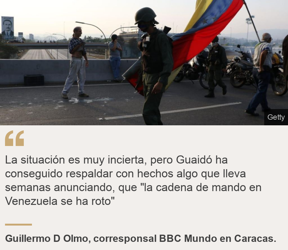 "La situación es muy incierta, pero Guaidó ha conseguido respaldar con hechos algo que lleva semanas anunciando, que "la cadena de mando en Venezuela se ha roto"", Source: Guillermo D Olmo, corresponsal BBC Mundo en Caracas. , Source description: , Image: Soldado con la bandera