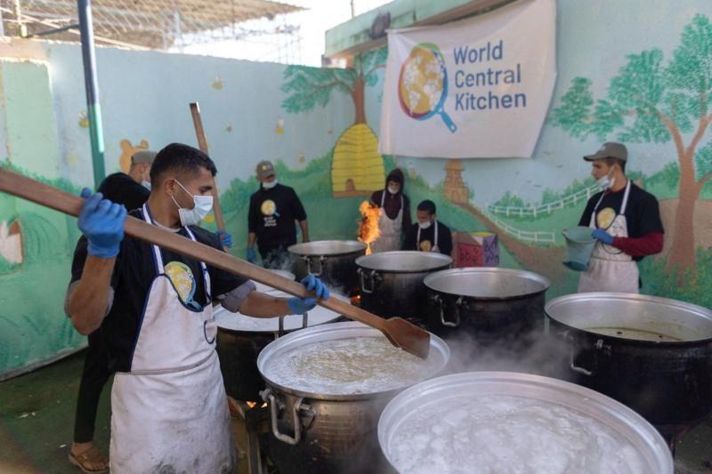 A group of aid workers cooking food in large pots