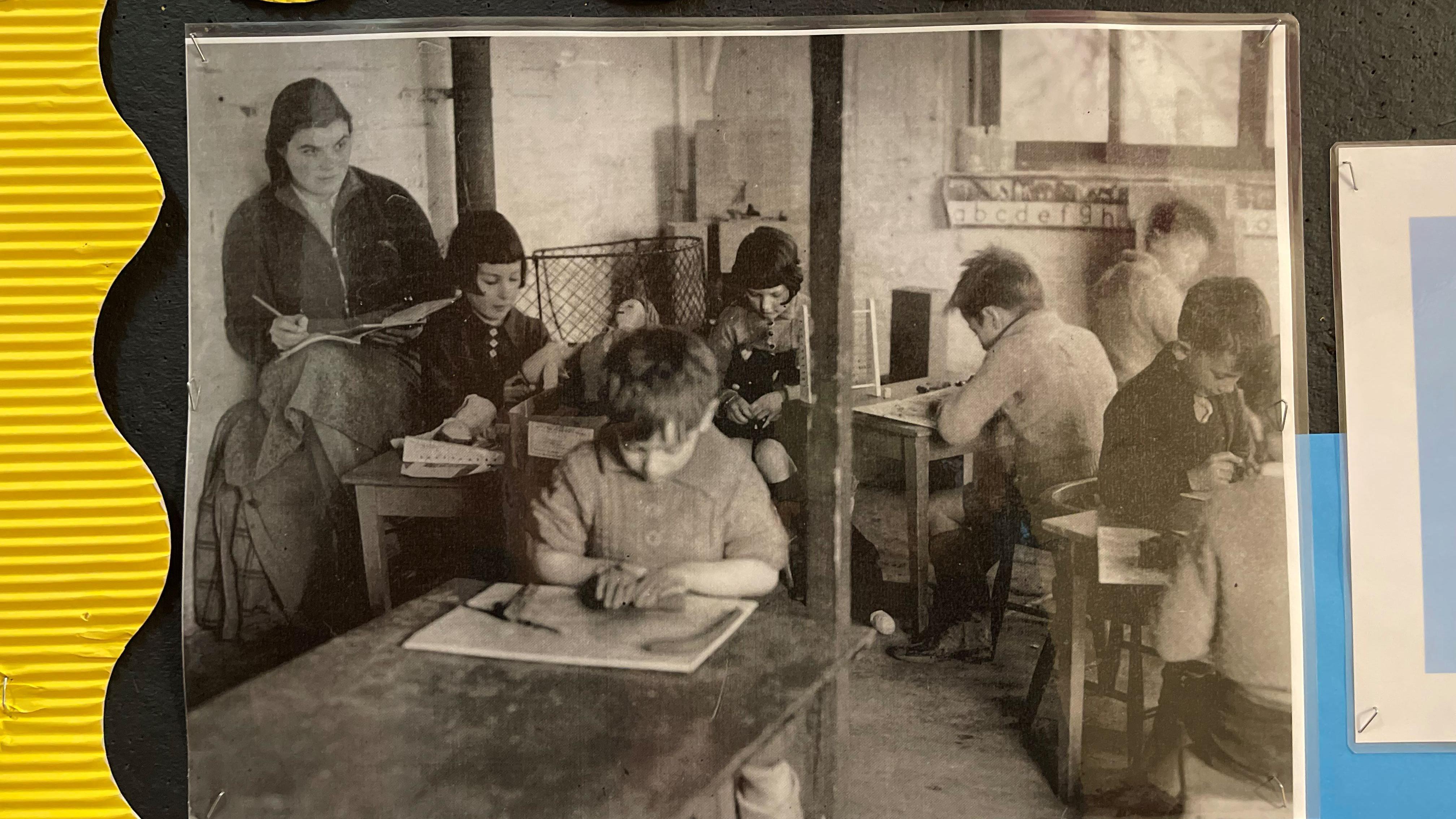 Foto antigua de niños estudiando.
