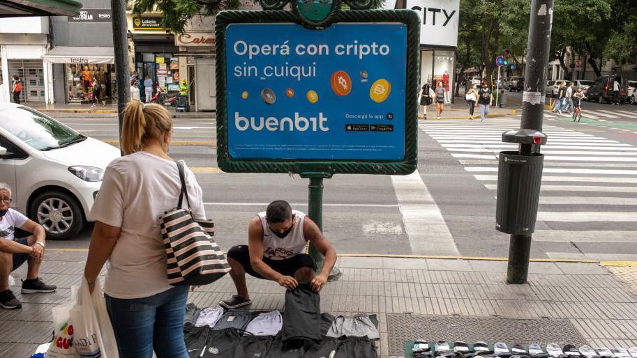 Un aviso para una plataforma de criptomonedas en una calle de Buenos Aires.