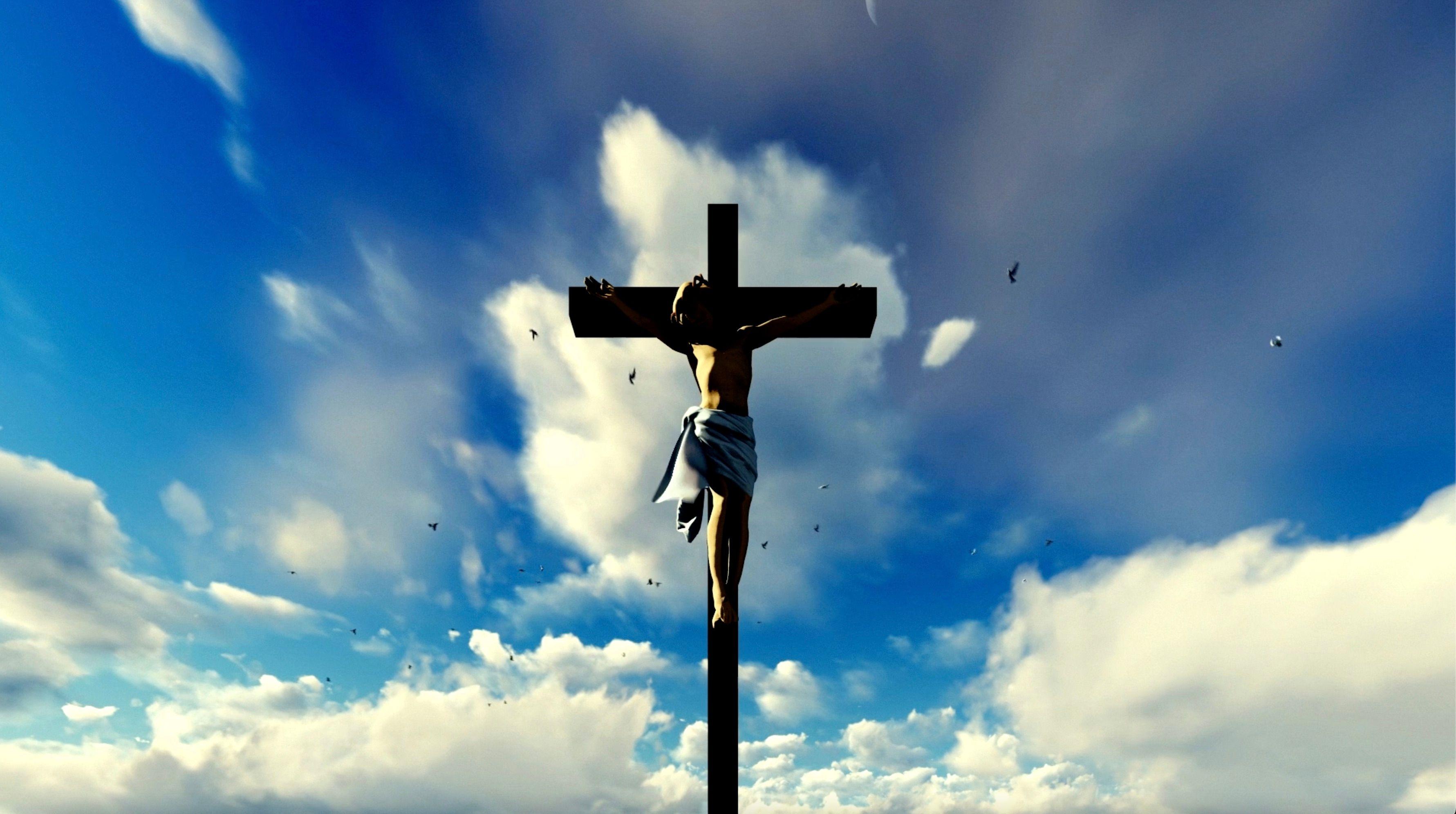 Jesus Christ nailed to the cross with clouds behind him