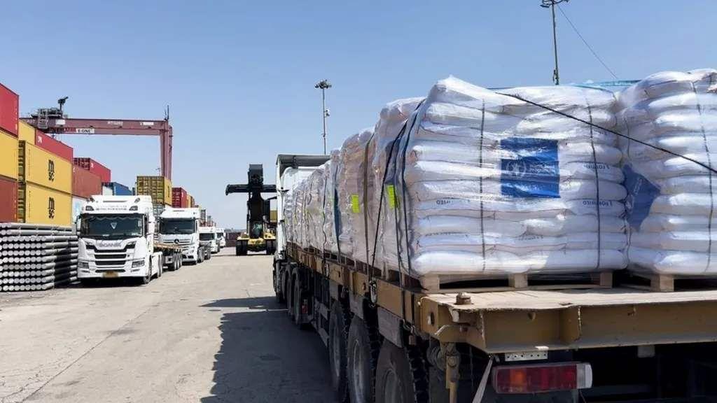تقوم شاحنات برنامج الأغذية العالمي التابع للأمم المتحدة بنقل الدقيق إلى غزة من ميناء الحاويات في أشدود الإسرائيلي