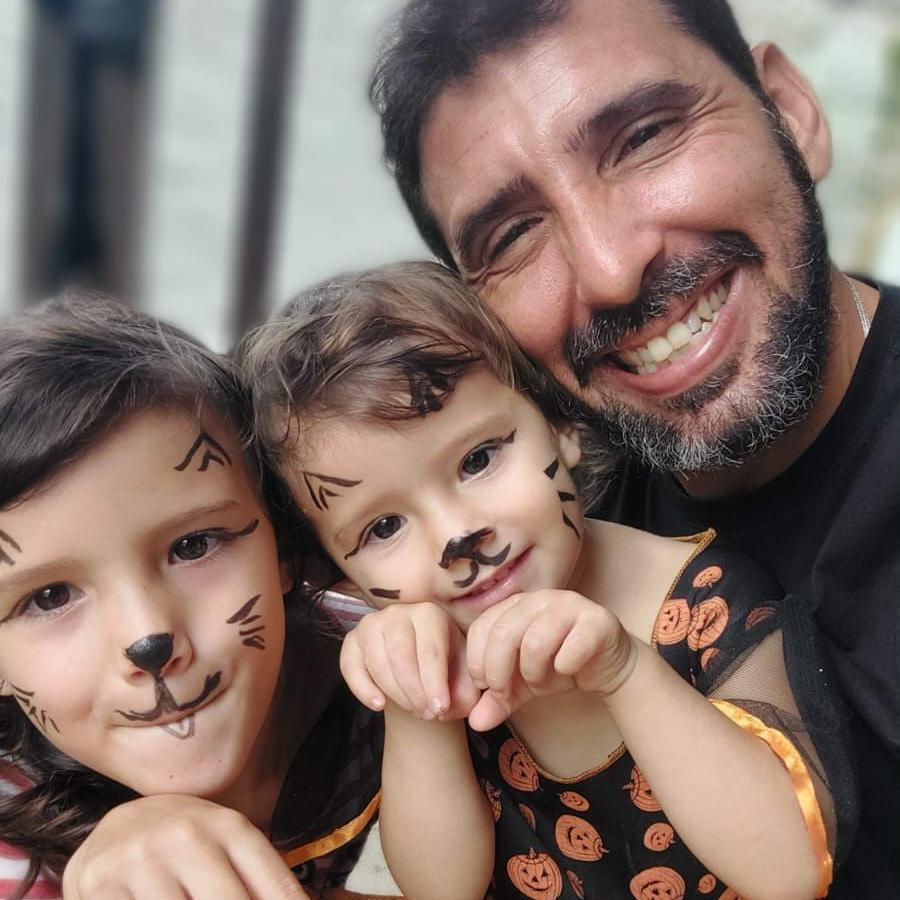 Tiago com as filhas, duas meninas com rostos pintados de coelhinho