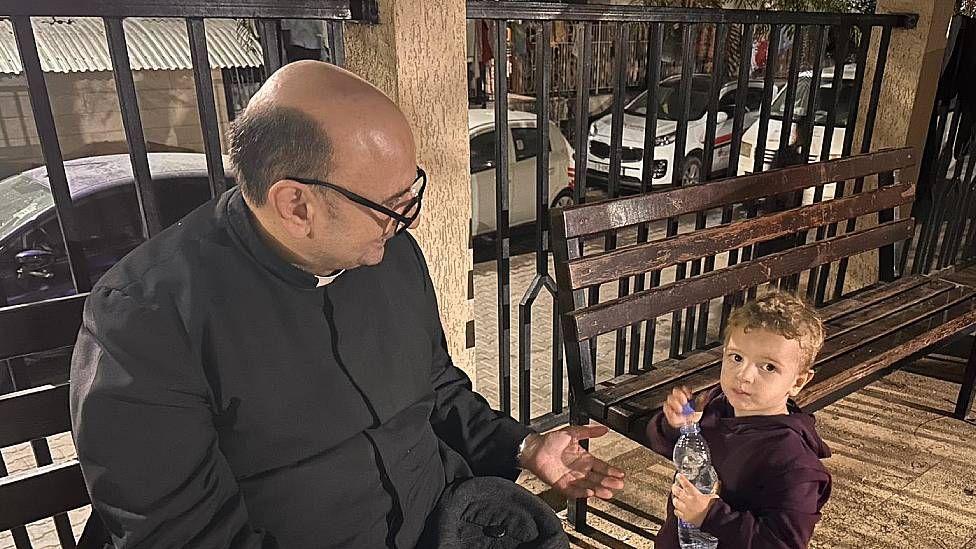 El padre Gabriel con un niño