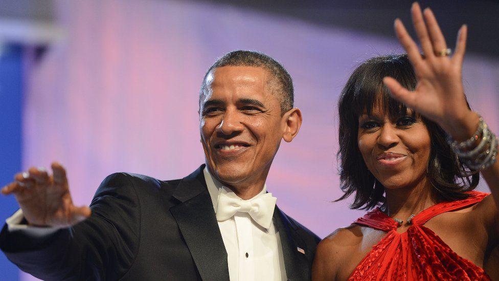 Barack y Michelle Obama saludando.