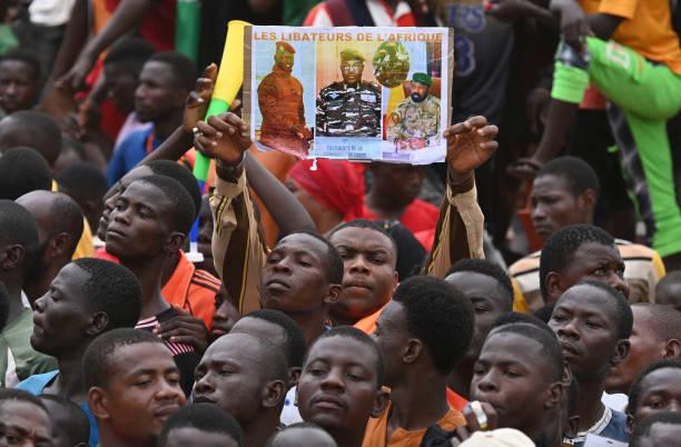 متظاهرون خارج القاعدة الجوية الفرنسية في نيامي يحملون صور الجنرال عبد الرحمن تياني الذي تولى السلطة بعد الانقلاب.