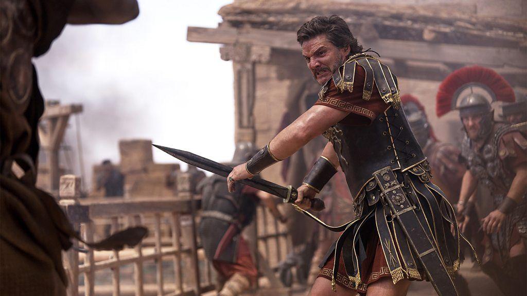 O ator Pedro Pascal, caracterizado como o general romano Acacius, luta com uma espada em cena do filme Gladiador 2