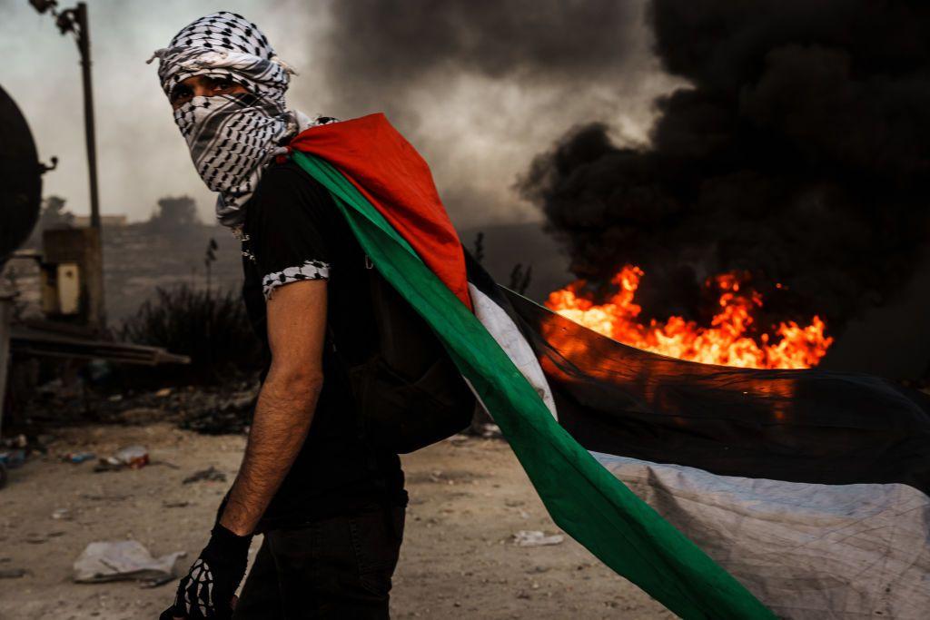 Seorang warga Palestina memprotes pendudukan Israel di Tepi Barat.