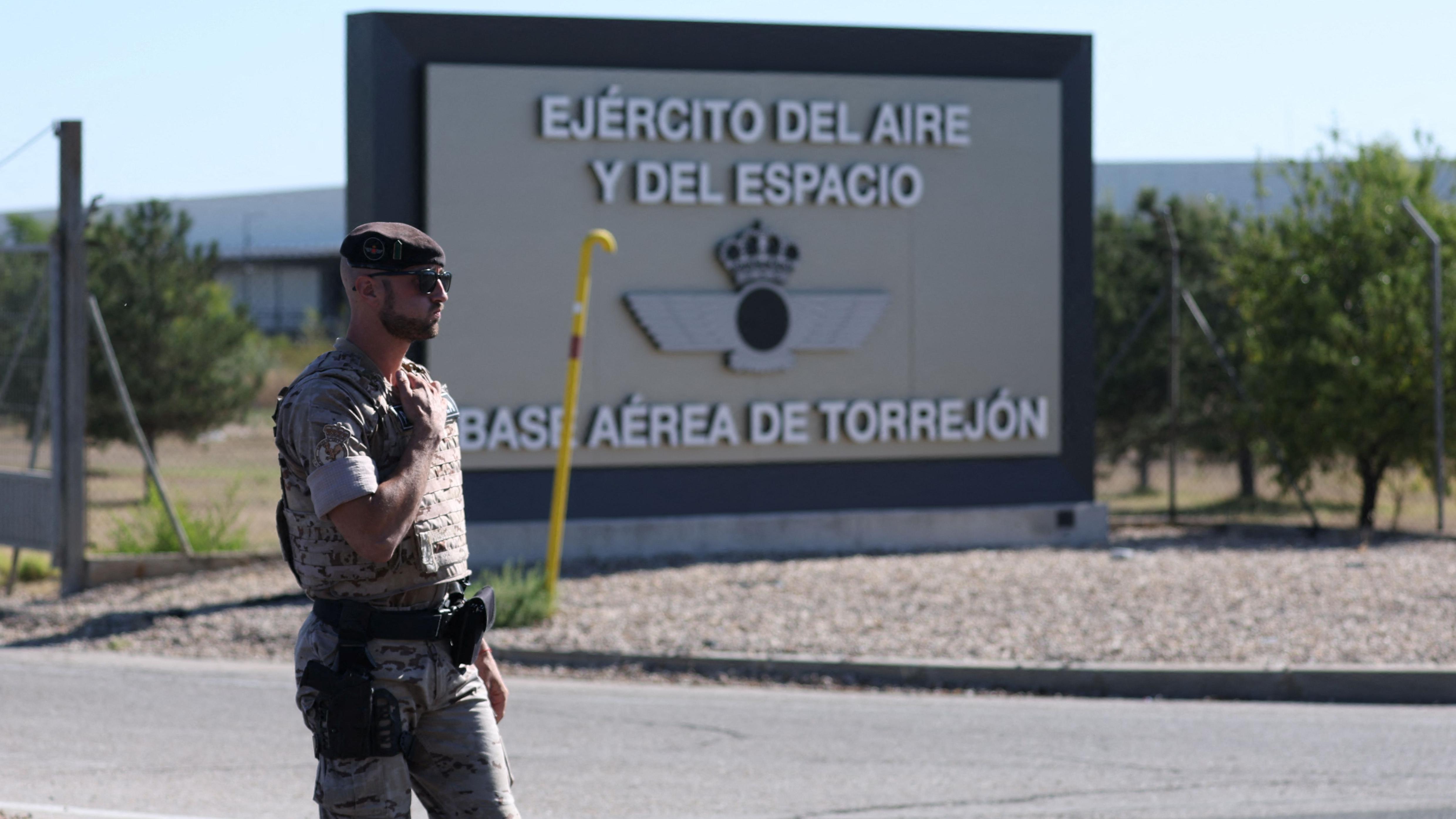 A soldier with a sign for the Torrejón air base behind him.