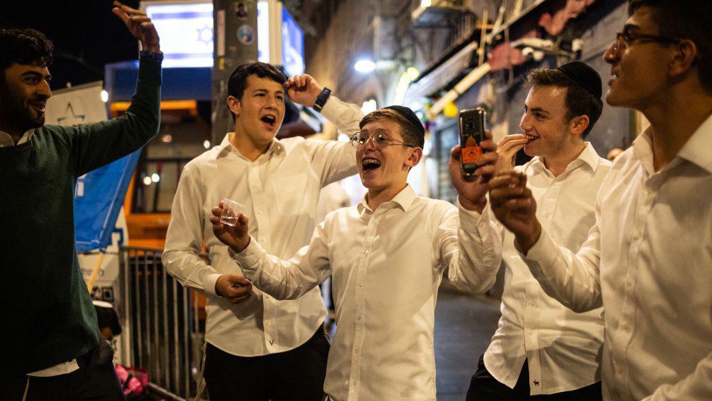 People celebrate after the Israeli army confirmed the death of Hamas leader Yahya Sinwar in Jerusalem.