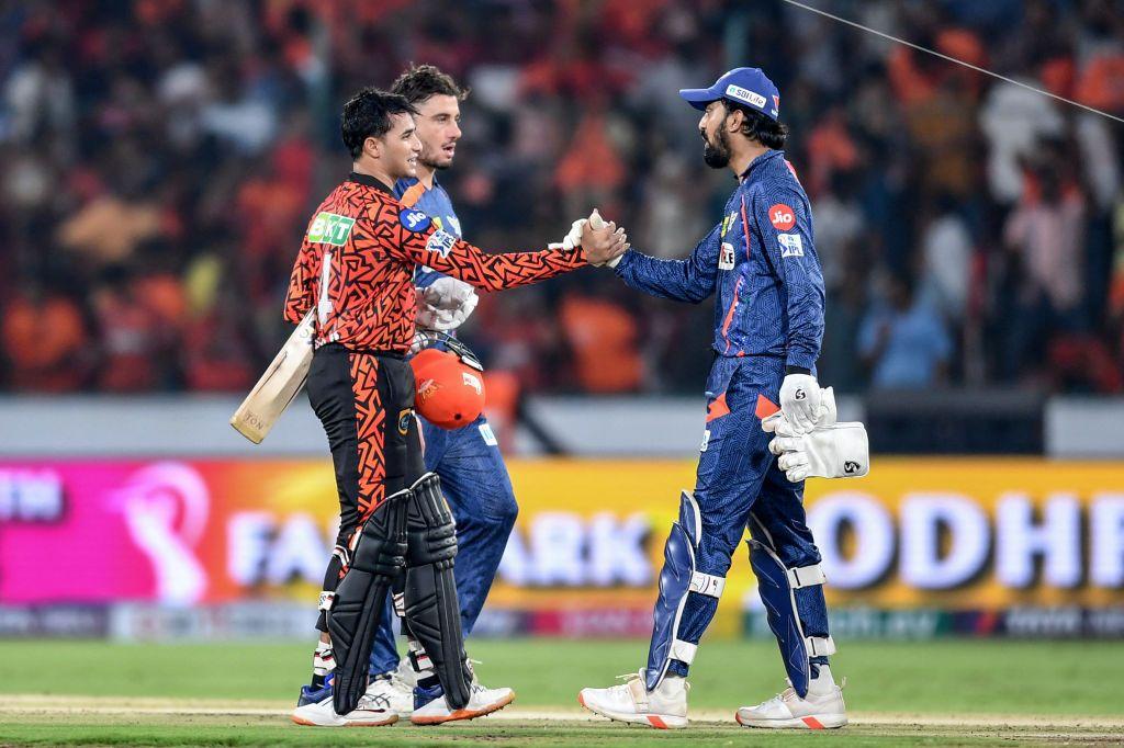 Sunrisers Hyderabad's Abhishek Sharma (L) is congratulated by Lucknow Super Giants' captain KL Rahul (R) for his innings