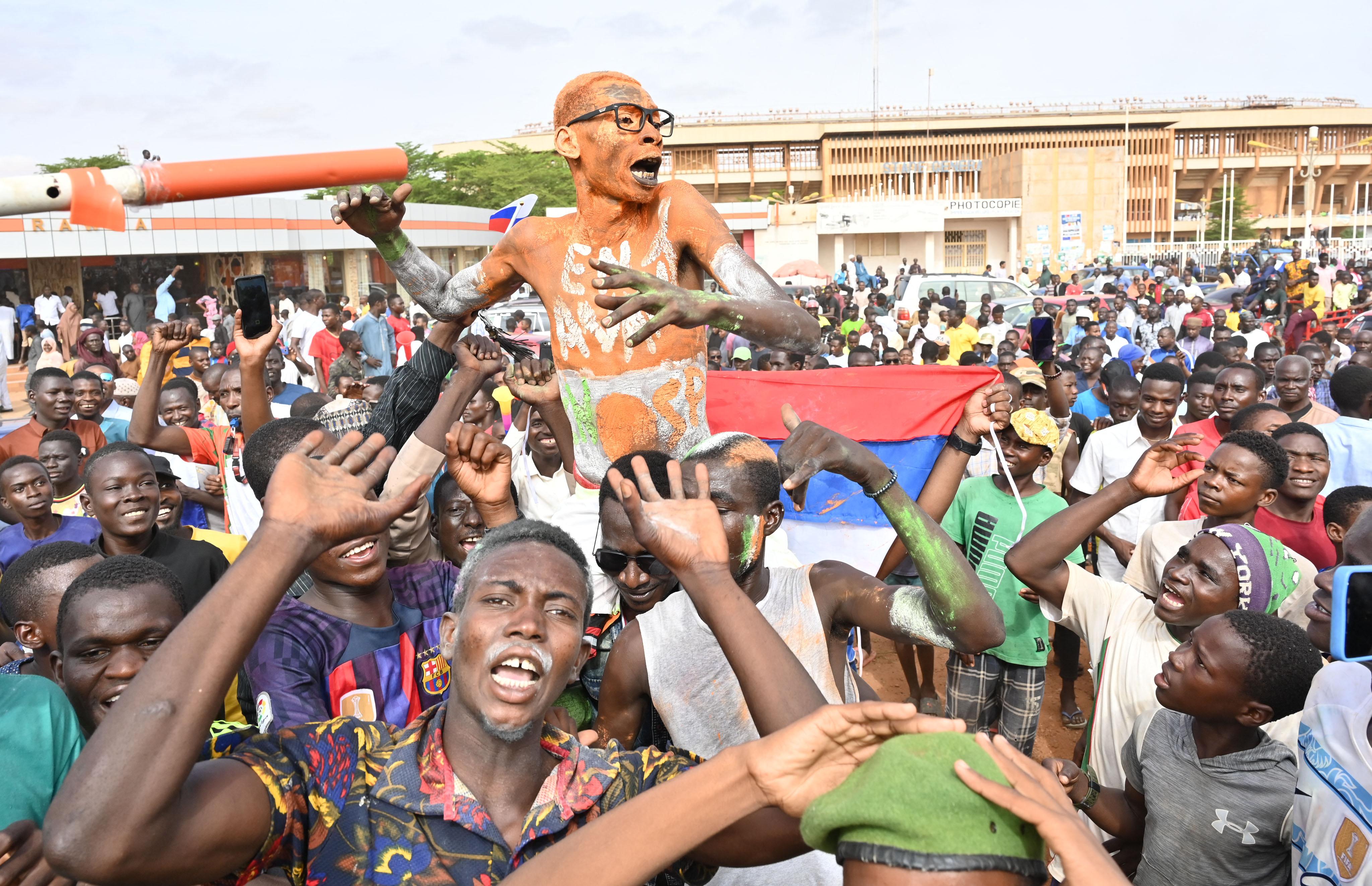 Supporters of the military coup gathering in the centre of the capital Niamey waving Nigerien and Russian flags