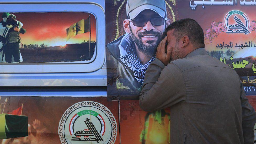 People attend the funeral ceremony of the member of Popular Mobilisation Forces (PMF, Hashd al-Shaabi) militia who was allegedly killed in a US airstrike in the Iraqi city of Babylon on 26 December 2023, in Baghdad, Iraq