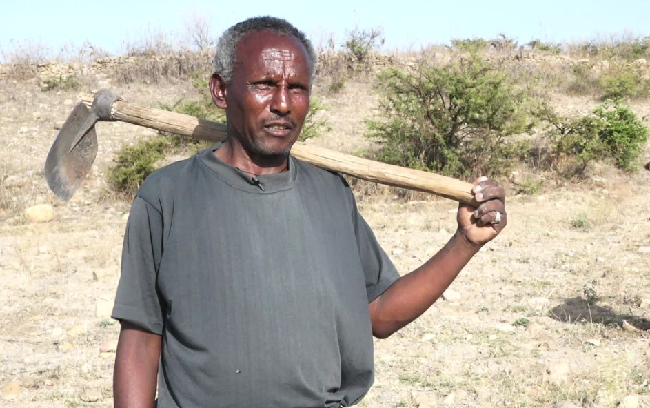 Man holding a farming tool