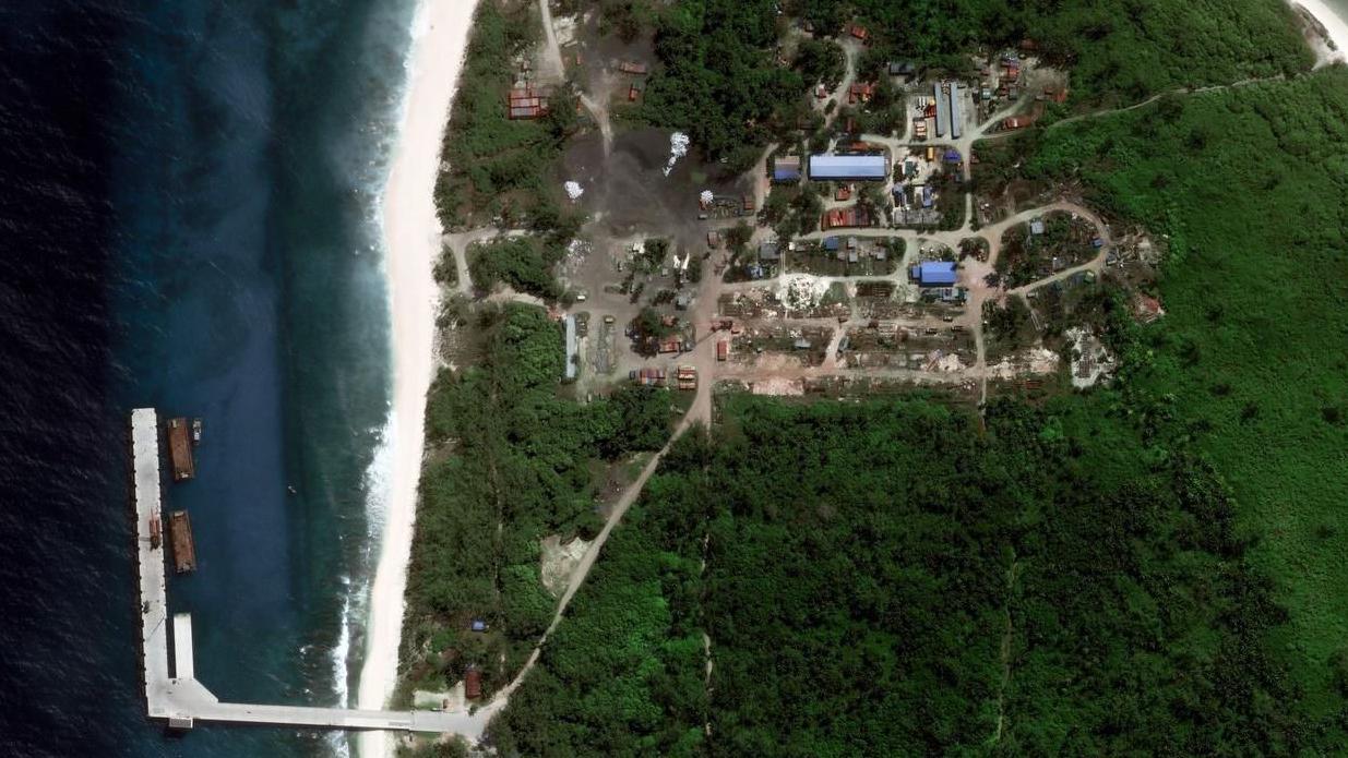 Close up satellite image of the jetty with ships alongside it; the image also shows development on the island