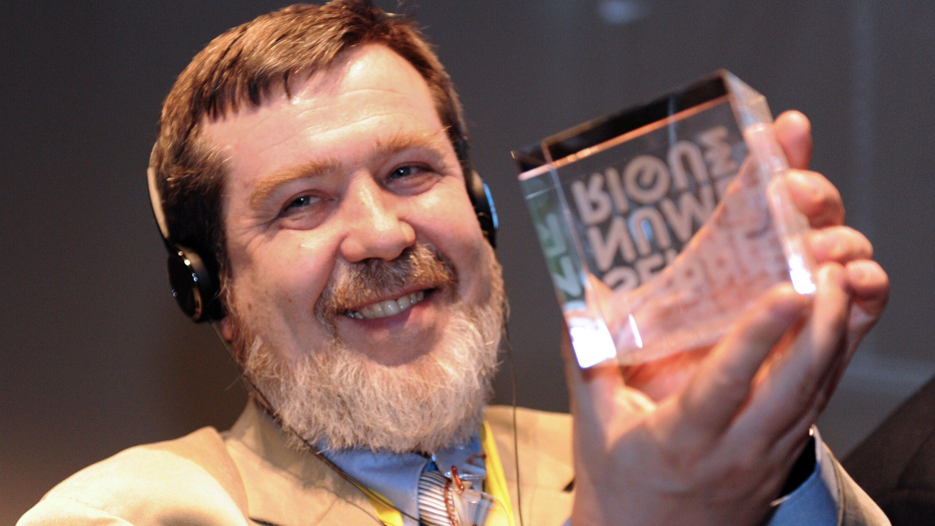 The Russian creator of the video game Tetris, Alexey Pajitnov, holds on 9 April 2015 the Digital Greenhouse trophy during the inauguration of 17,000 square meters of office space entirely dedicated to digital creation in the northern French city of Valenciennes