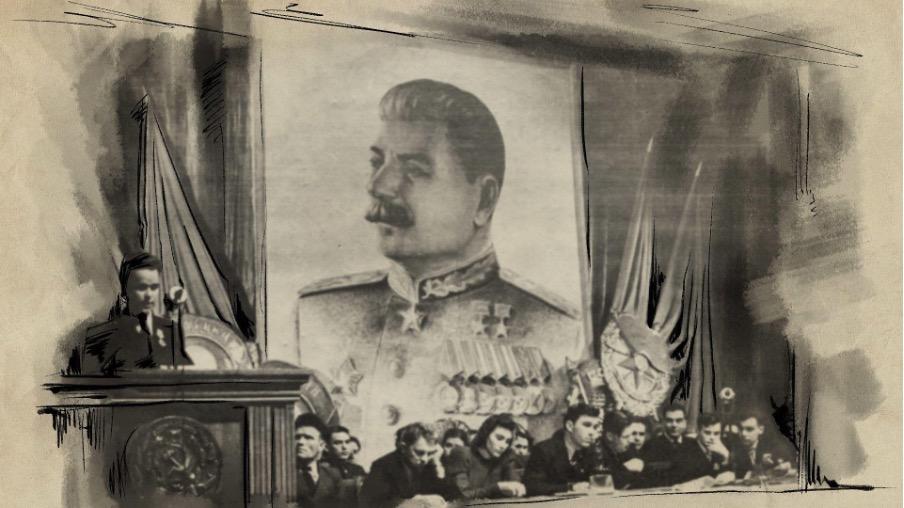 Pessoas sentam em salão de conferência, com foto de Stalin ao fundo