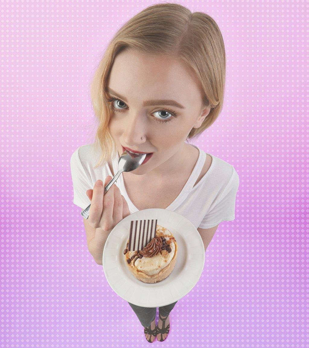Foto mostra mulher com um prato de doce