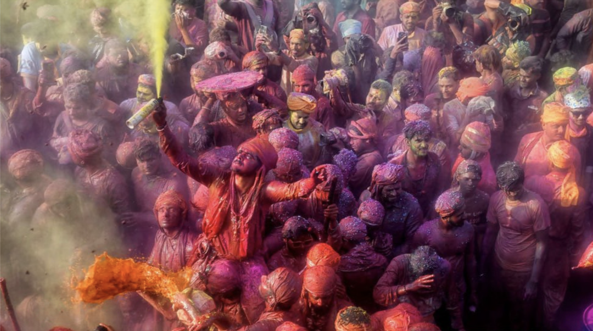 Hindu devotees play with colorful powders (Gulal) at the Radharani Temple of Nandgaon