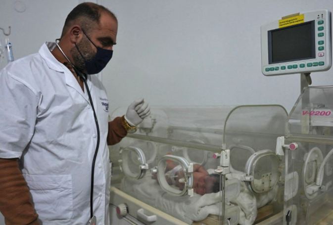 Doctor looking after orphaned baby in hospital 