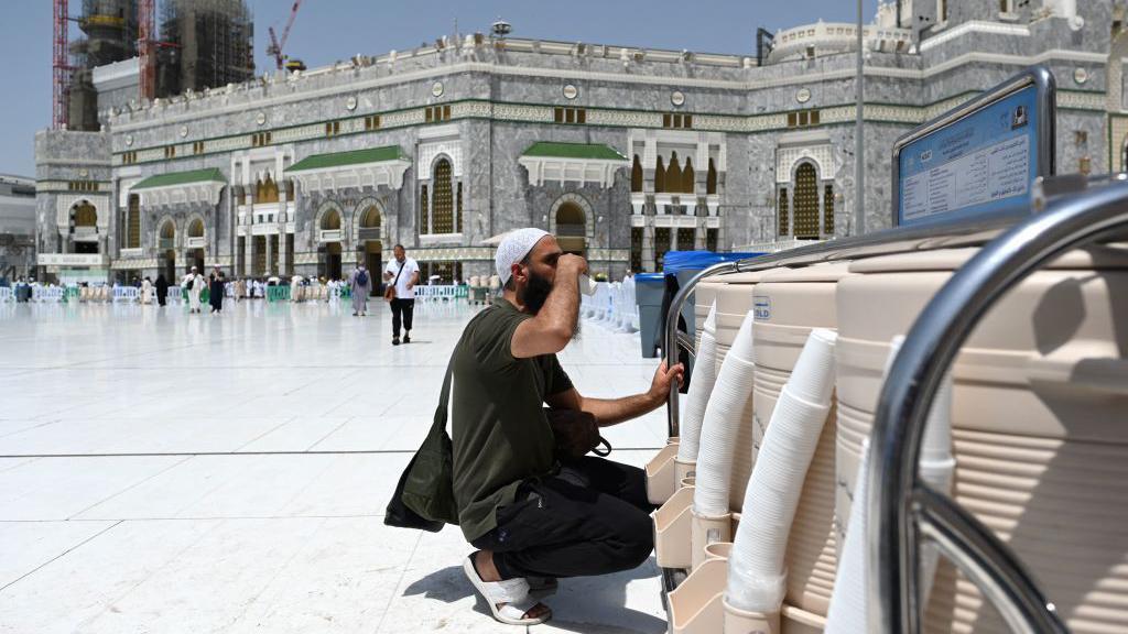 A pilgrim drinks Zamzam water at the Grand Mosque in the holy city of Mecca on June 25, 2023