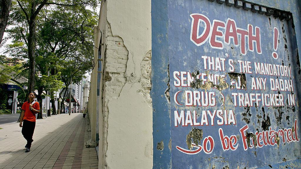 Tulisan dinding tentang hukuman mati wajib Malaysia untuk perdagangan narkoba di pusat kota Kuala Lumpur.