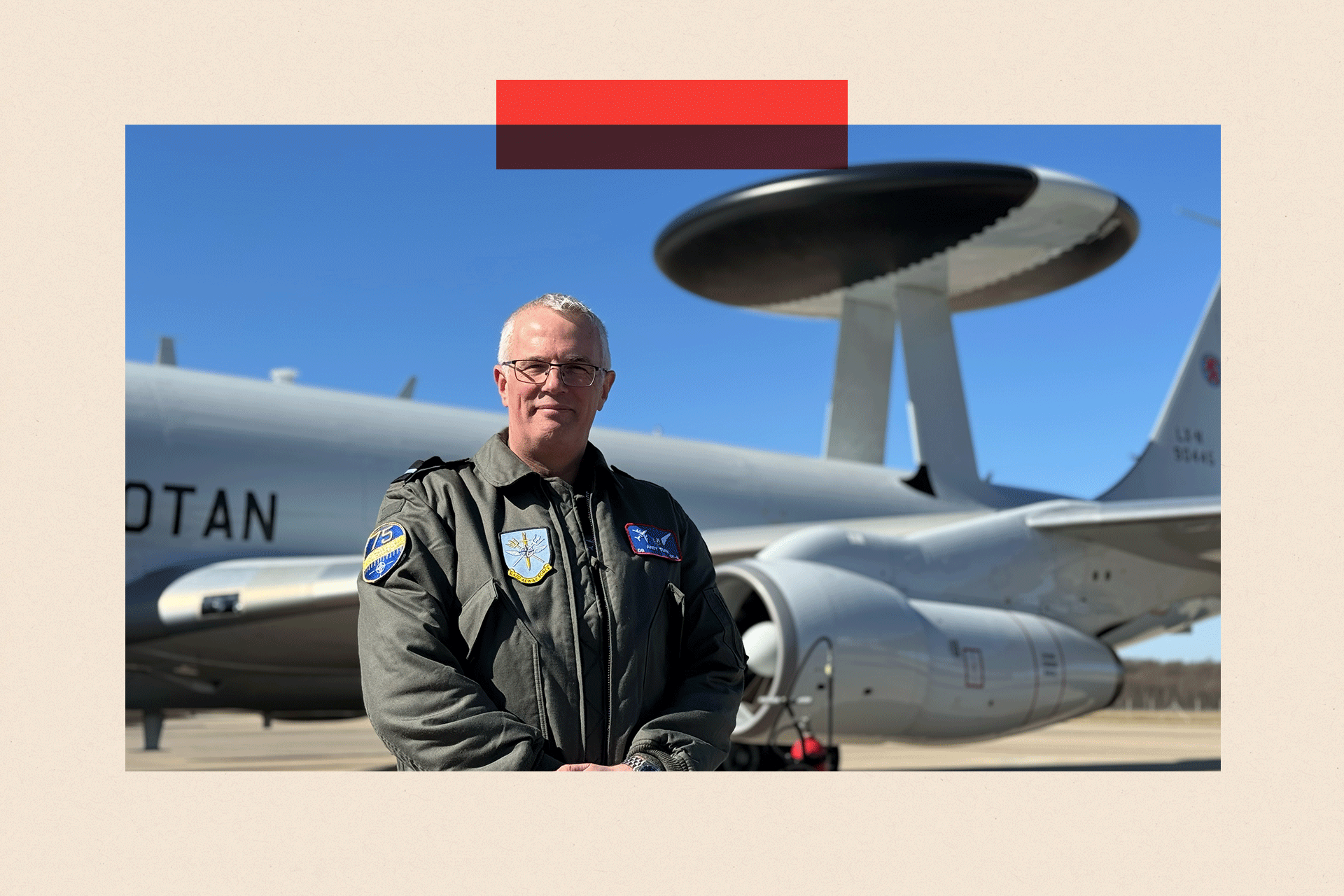 AWACS Dep Commander Andy Turk stands in front of a plane