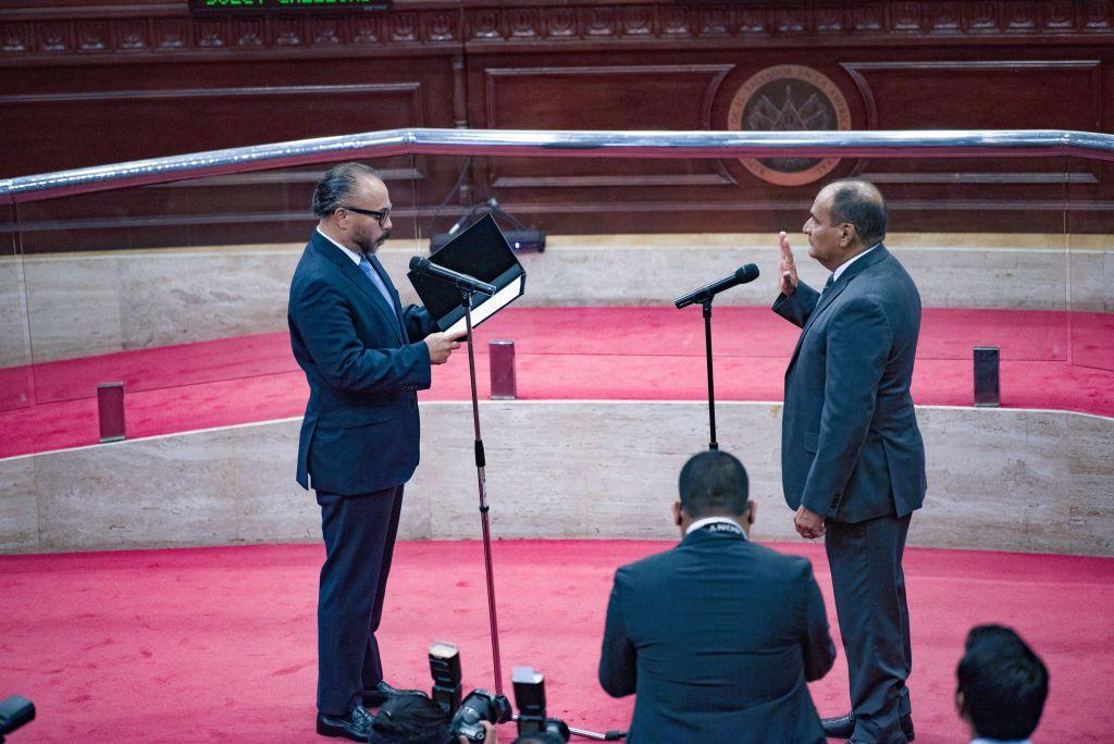 Supreme Court Judge Oscar López (R) takes the oath before Congressman Ernesto Castro (L). The recently sworn-in Congress approved the dismissal of the Constitutional Court and the Attorney General of El Salvador, as 56 of the 84 representatives of Congress are members of Salvadoran President Nayib Bukele's New Ideas party. (Photo by Camilo Freedman/SOPA Images/LightRocket via Getty Images)