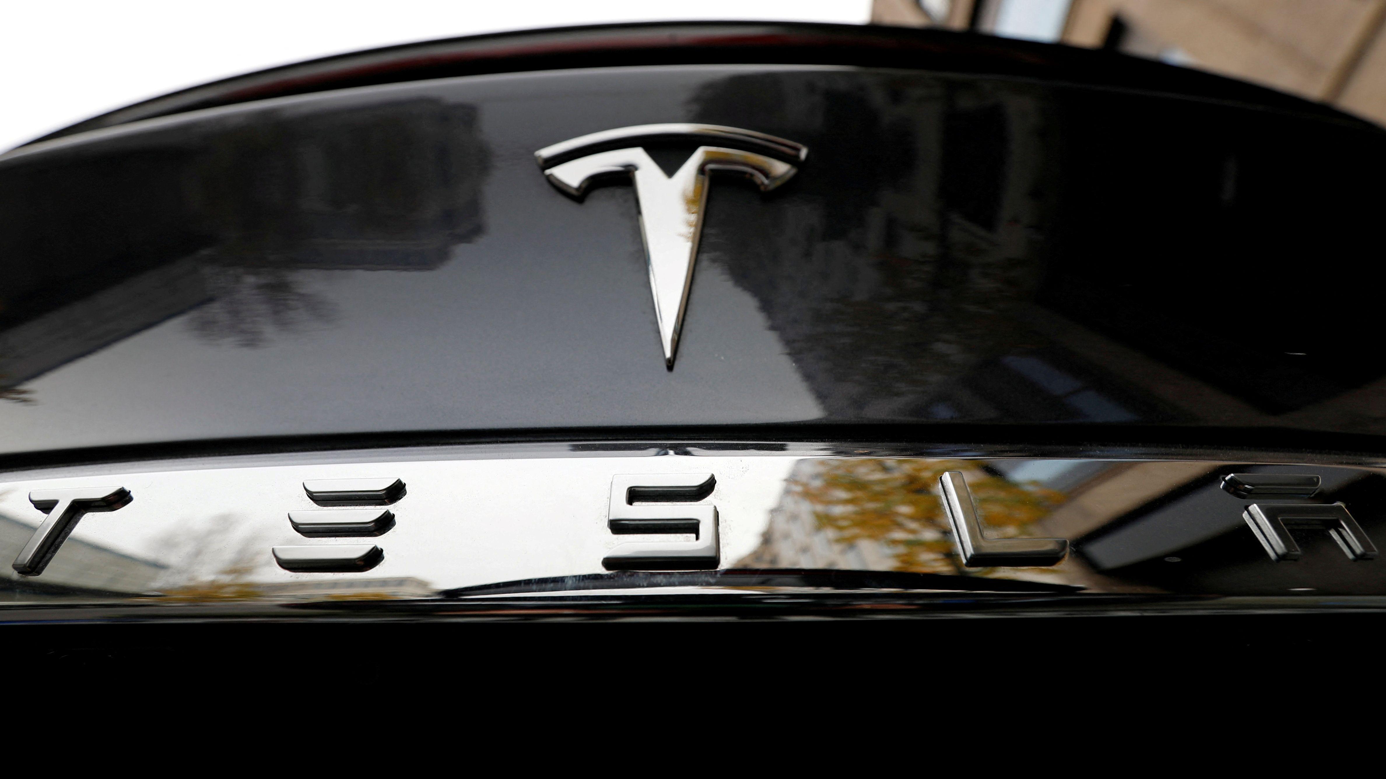 Tesla brings forward new models as profits slump
