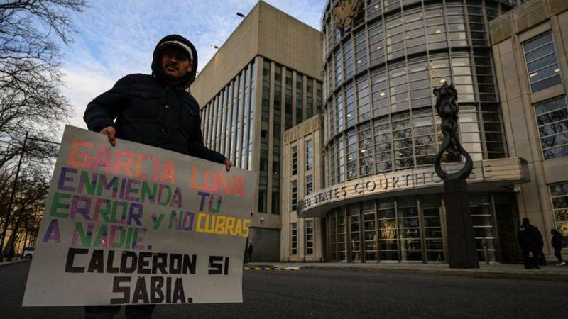 Homem protesta com cartaz contra Garcia Luna em frente a tribunal