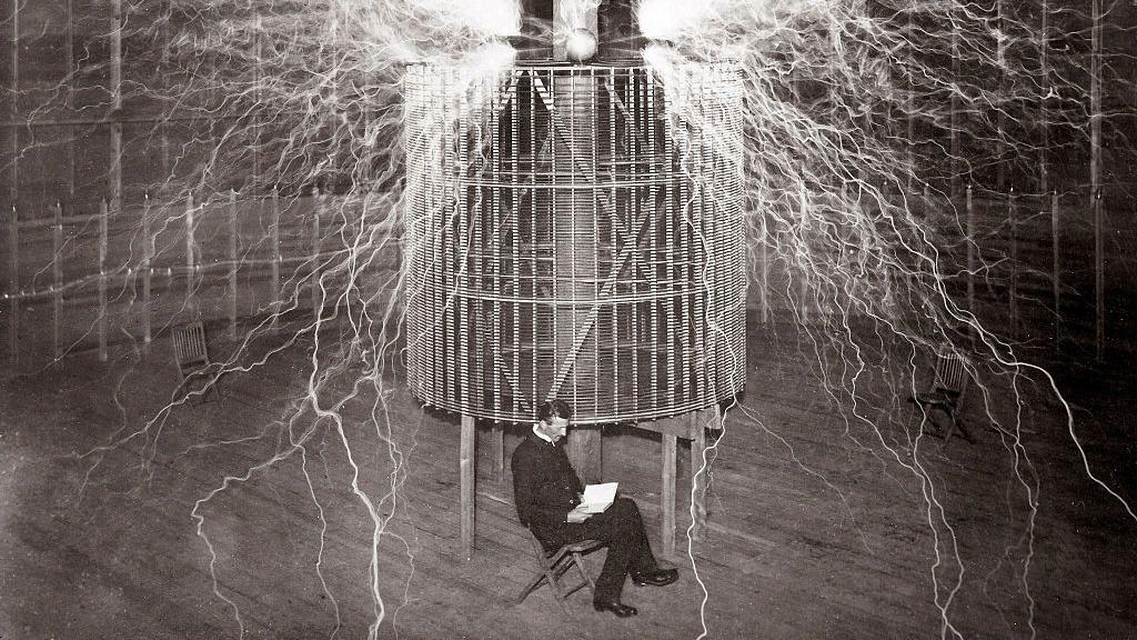 Nikola Tesla sentado em seu laboratório no Colorado Springs