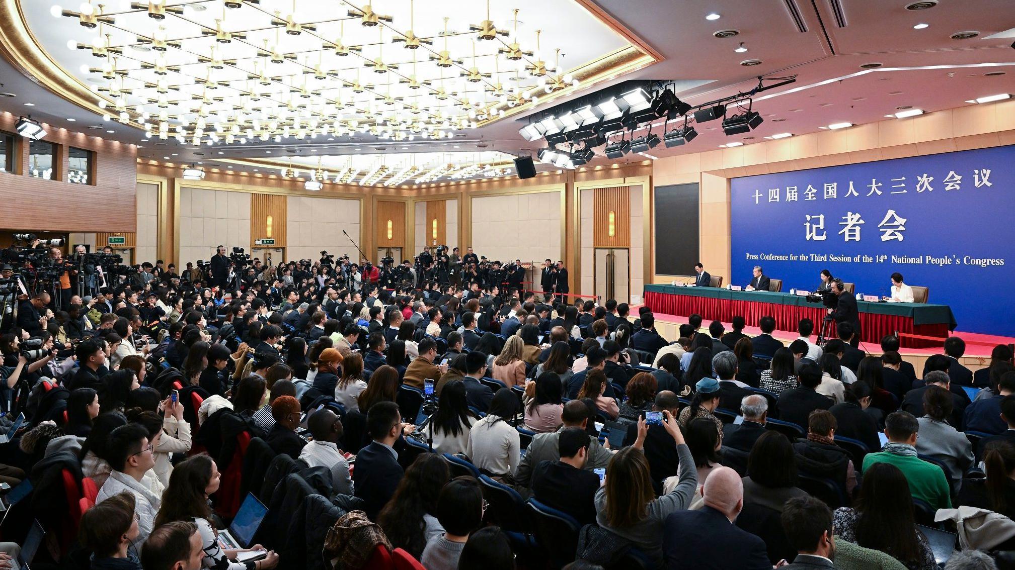 China's Foreign Minister Wang Yi (podium, 2nd L) speaks at a press conference during the ongoing National People's Congress (NPC) in Beijing on March 7, 2025