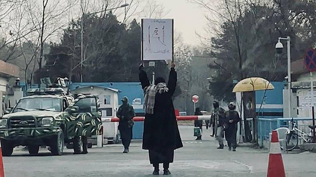 A woman protesting the Taliban's ban on education alone in front of Kabul University. Published on social media and shared with the BBC