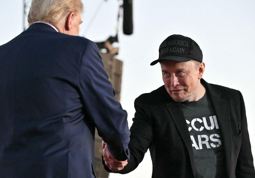 Elon Musk shaking hands with Donald Trump