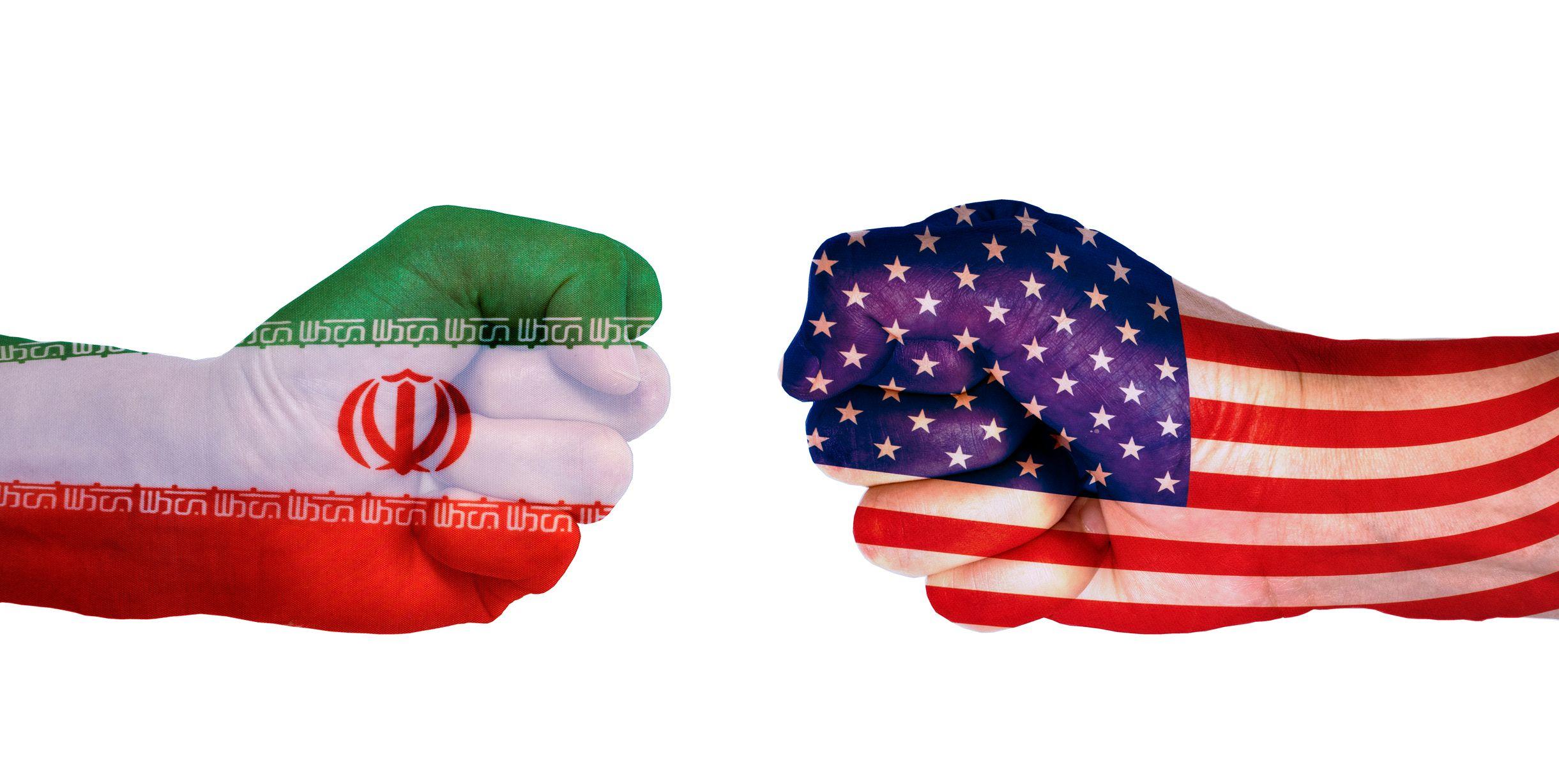 Fists in the colours of the US and Iran flags facing each other