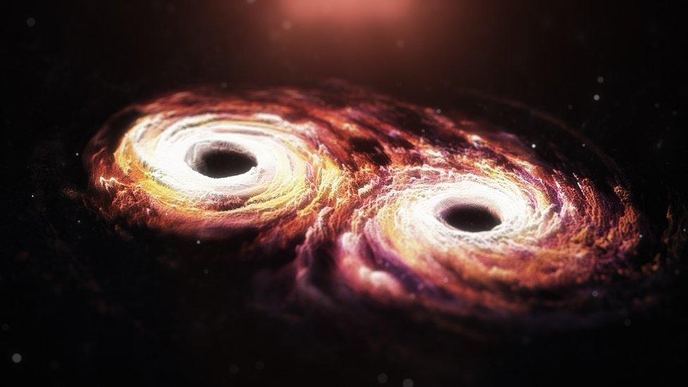 Impresión artística de dos agujeros negros con forma de espiral colisionando.