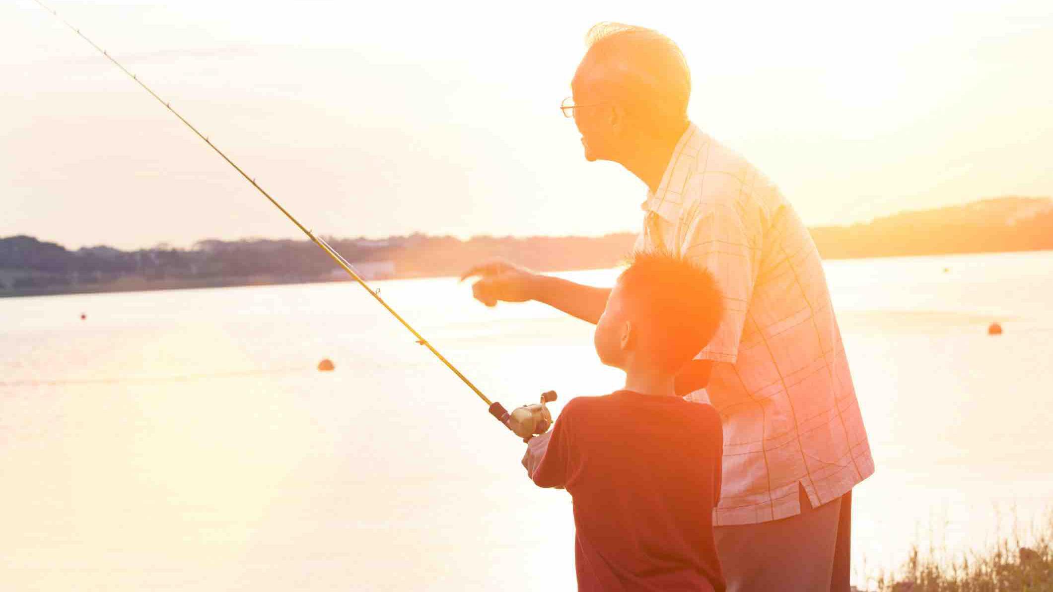 A boy and a grandfather fishing 