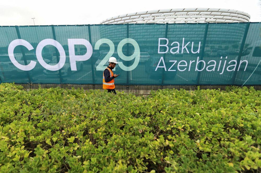 Radnik prolazi pored olimpijskog stadiona u Bakuu gde će se održati COP29