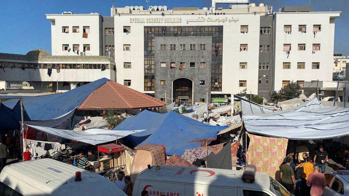 The view of the Al Shifa Hospital building from the outside, with the grounds packed with tents for people displaced by the war