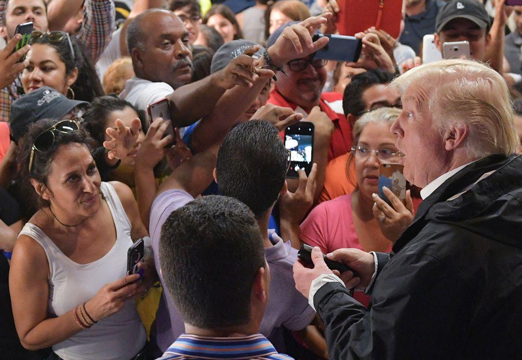 Donald Trump, a la derecha, rodeado de personas en una visita a Puerto Rico tras el huracán María de 2017. 