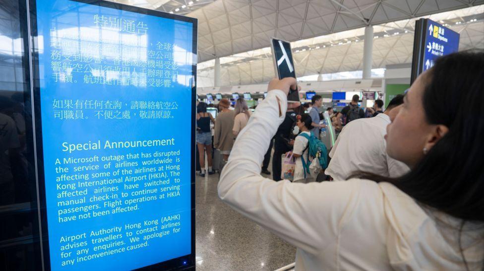 Una mujer en el aeropuerto de Hong Kong revisa el intinerario de vuelo