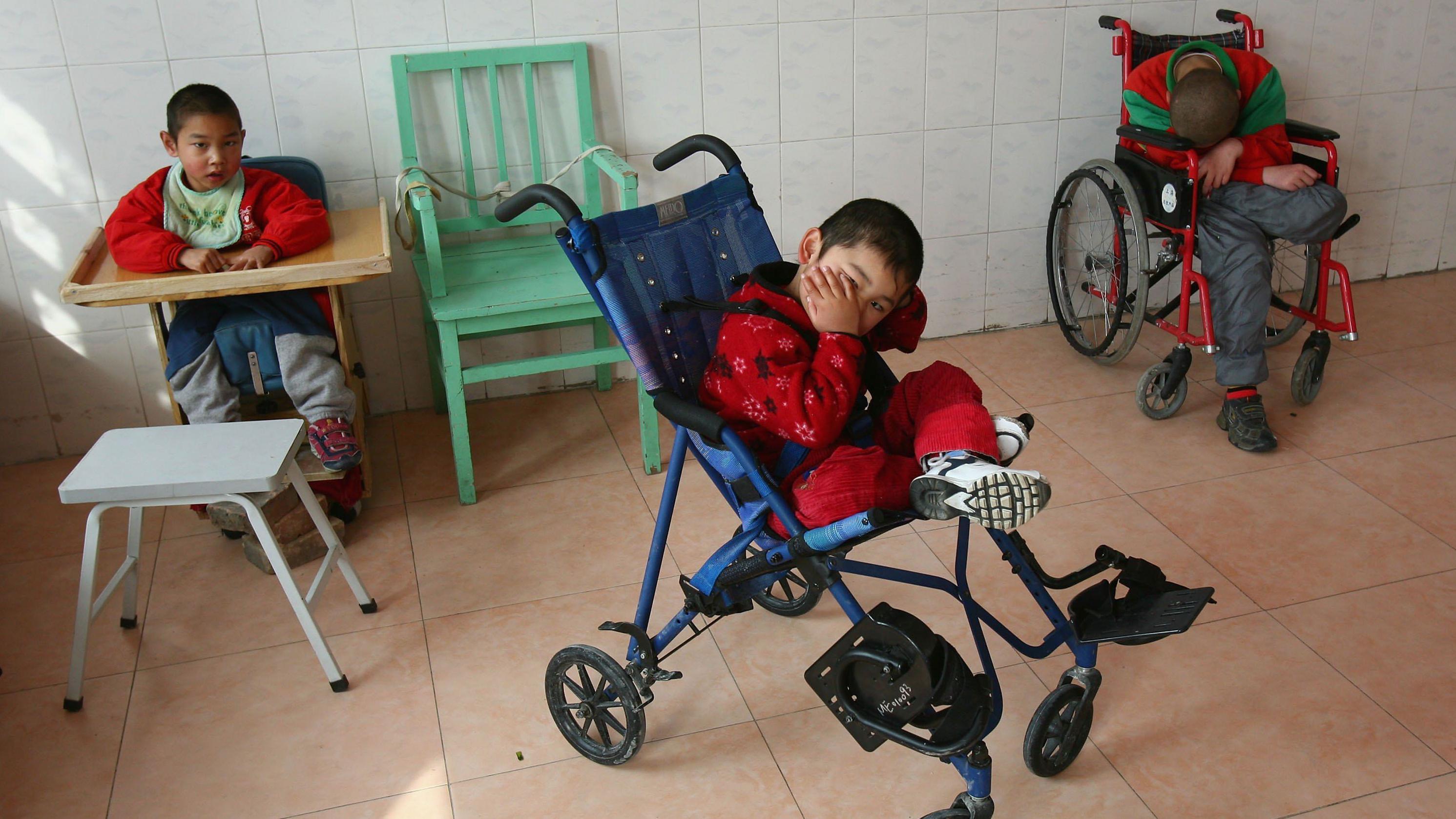 Children wait to be fed lunch at the Xining Orphan and Disabled Children Welfare Center October 21, 2006 in Xining of Qinghai Province, China.